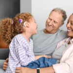 Parents with kid wearing a cochlea implant